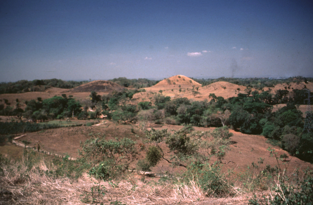 Hummocks of the Escuintla debris avalanche deposit, most likely from the Fuego-Acatenango massif, cover the Pacific coastal plain of Guatemala about 30 km from their source. This massive volcanic landslide is the largest known in Guatemala. The avalanche traveled about 50 km from the Fuego-Acatenango massif and covered about 420 km2, with an estimated volume of about 15 km3. Photo by Bill Rose, 1988 (Michigan Technological University).