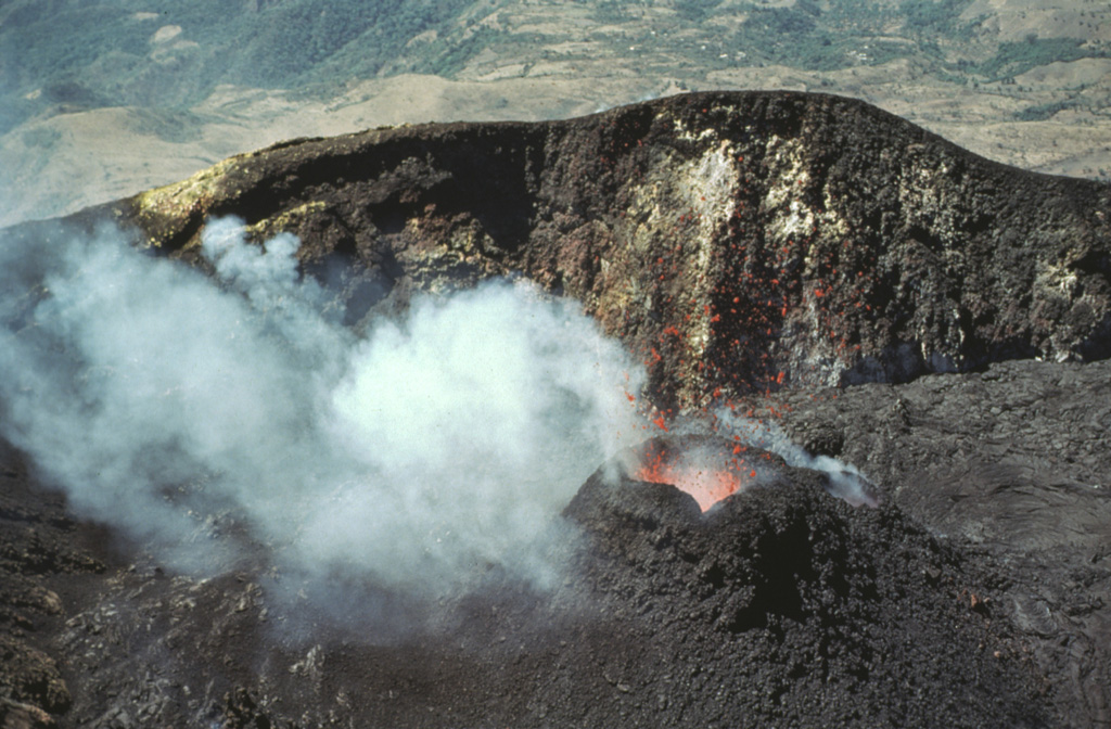 Incandescent lava spatter is ejected from a small cone in MacKenney crater in February 1981. Lava flows from the cone filled the crater floor and flowed out through a notch in the crater rim. Photo by Bill Rose, 1981 (Michigan Technological University).