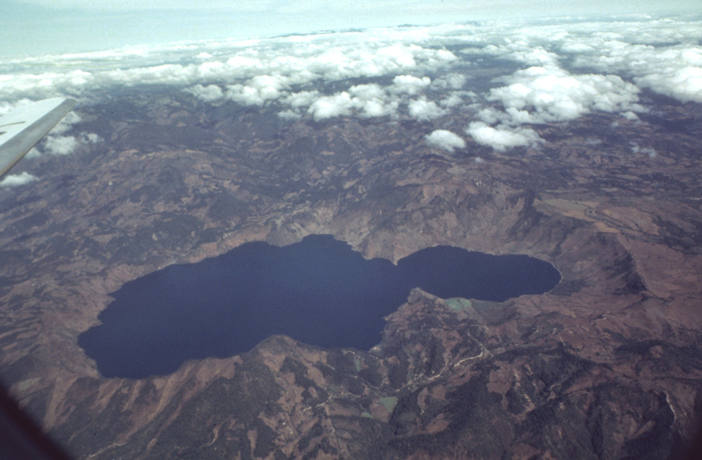Scenic Laguna de Ayarza fills a double caldera formed during the late Pleistocene.  The caldera lies about 40 km NE of the active volcanic front.  The older eastern caldera (left) was associated with eruption of the Mixta pumice fall and ashflow about 27,000 years ago, and the larger western caldera was formed during eruption of the Pinos Altos airfall pumice and Tapalapa ashflows radiocarbon dated at about 23,100 years before present.  Bathymetry of the lake floor shows no evidence for post-caldera eruptions.      Photo by Bill Rose, 1982 (Michigan Technological University).