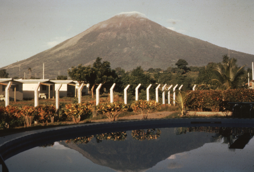 The northern slopes of the symmetrical cone of San Miguel are seen here from the city of San Miguel north of the volcano.  A deep crater that has been frequently modified by historical eruptions (recorded since the early 16th century) caps the truncated summit of the basaltic-to-andesitic volcano.  Radial fissures on its flanks have fed a series of fresh lava flows, including a NE-flank flow in 1762 that currently underlies the outskirts of the city of San Miguel, the third largest in El Salvador. Photo by Bill Rose, 1971 (Michigan Technological University).