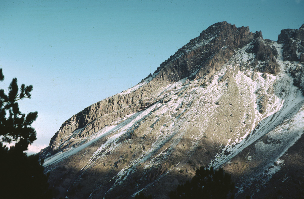 This 1978 photo shows an andesite lava flow several hundred meters long formed the northern summit ridge of Nevado de Colima, which was constructed within the youngest of three overlapping collapse scarps. This post-caldera cone has been extensively glaciated. Photo by Jim Luhr, 1978 (Smithsonian Institution).