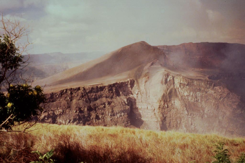Santiago crater, seen here from the NE, formed in 1853.  A strong detonation on April 9, 1853 was followed by heavy gas emission with no noticeable ejection of pyroclastic material.  Flames were seen at the summit of the volcano on the night of September 15 from the town of Masatepe and later investigation revealed a new 80 x 65 m wide crater (later known as Santiago) with incandescent lava surrounded by volcanic bombs.  Santiago pit crater expanded significantly in 1858-1859 and is now 600 m wide. Photo by Jaime Incer, 1996.