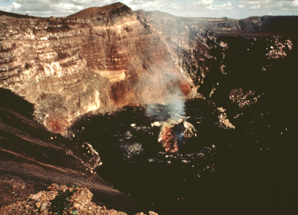 Fume rises in 1978 from a vent on the floor of Santiago crater, seen here from its SE rim.  The floor of the crater is covered by fresh lava flows erupted between 1965 and 1972.  A lava lake was present on the part of the crater floor until 1979, and intermittent explosive activity continued until 1985. Photo by Jaime Incer, 1978.