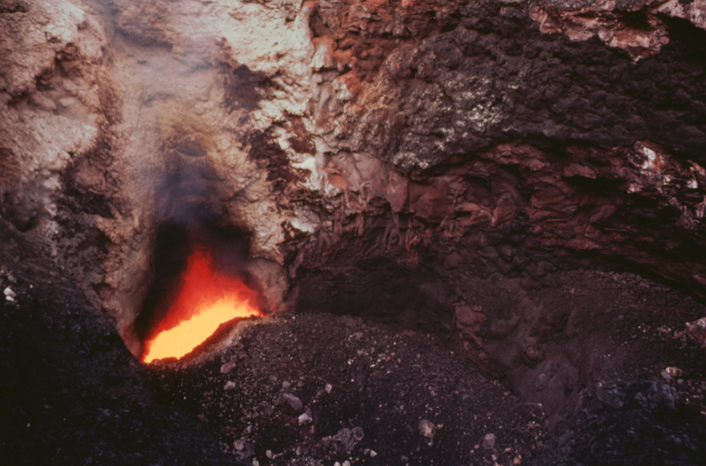 Incandescent magma is visible in 1996 at the bottom of Santiago crater from a vent below the south crater wall.  A small strombolian eruption on December 5, 1996 ejected blocks (<10 cm in diameter), ash, and Pele's hair.  Some of the inner crater walls collapsed, partly closing the incandescent vent.  Prior to this eruption the vent's gas temperature was 1,084°C; afterwards, it dropped to 360°C.  Photo by Jaime Incer, 1996.