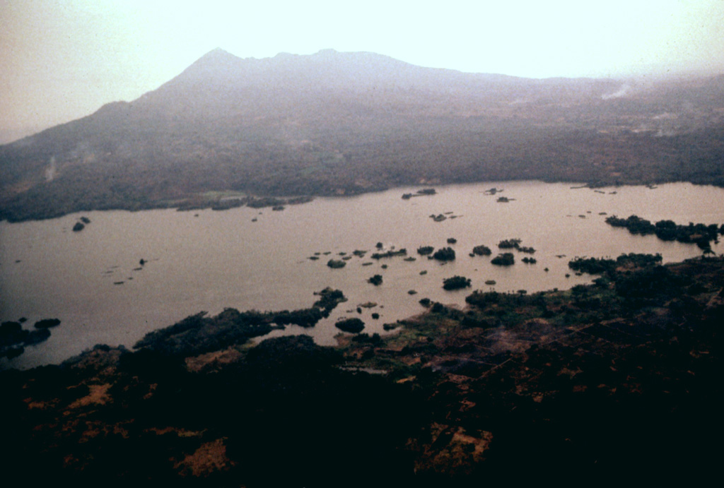 Mombacho volcano in the background collapsed during the late Pleistocene, producing a debris avalanche that swept into Lake Nicaragua, deposting debris that accumulated to form the Aseses Peninsula in the foreground.  The surface of the avalanche deposit lies below the lake surface immediately offshore of the mainland, creating the Bay of Aseses in the middle of the photo.  Portions of the deposit rise above the lake surface, forming hundreds of small islands. Photo by Jaime Incer.