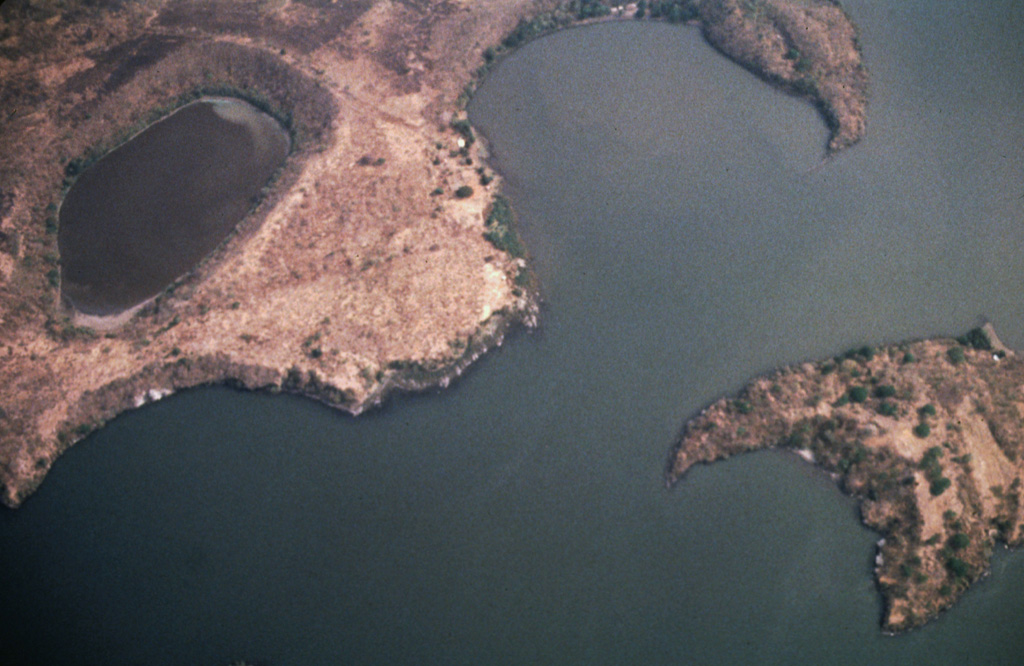 A cluster of maars forms the NW tip of Zapatera Island in this aerial view with north to the bottom.  Laguna de Zapatera lies at the upper left, and Punta Rua, the peninsula at the upper right, forms part of the western rim of a maar enclosing the Ensenada de Chiqueros.  Isla El Muerto lies just offshore at the lower right. Photo by Franco Penalba, 1994 (courtesy of Jaime Incer).