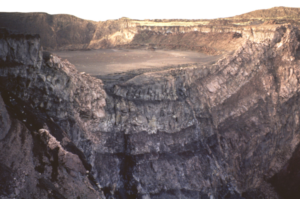 Nindirí crater is partially truncated by the walls of Santiago crater, which formed in 1858-1859.  The crater walls reveal flows from lava lakes erupted between 1524 and 1670.  An active lava lake was apparently present in Nindirí crater from 1524 to 1544, as reported by Spanish Friars passing through Nicaragua.  The Spanish chronicler Oviedo observed the lava lake when he climbed the volcano in July 1529.  In 1534 Friar Bartolomé de las Casas reported that a letter could be read at night in the town of Nindirí (6 km away) by the glow of lava.   Photo by Jaime Incer, 1991.