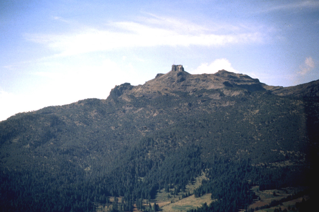 The smooth profile of the Cofre de Perote volcano is modified on the NE side by steep escarpments. The morphology of the summit reflects both edifice collapse and glacial erosion. Dacite lava flows can be seen on the right-hand horizon. Photo by Hugo Delgado, 1997 (Universidad Nacional Autónoma de México).
