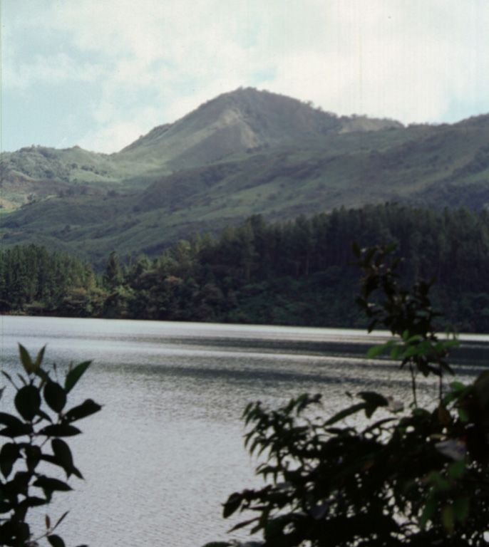 Cerro Corero de la Charca rising above the western shore of Laguna La Yeguada is the youngest silicic feature of La Yeguada complex (also known as Chitra-Calobre).  The compound 1229-m-high rhyodacitic lava dome was erupted about 220,000 years ago within a 1.5-km-wide caldera and produced pyroclastic-flow deposits that extend to the SE.  This eruption occurred at the northern end of the El Castillo horst and marked its latest activity. Photo by Paul Kimberly, 1998 (Smithsonian Institution).