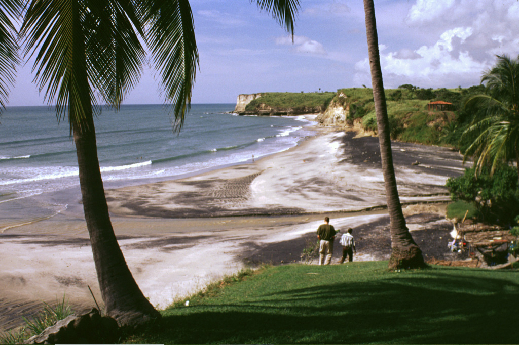 These headlands along the Pacific coast south of El Valle volcano consist of ignimbrite deposits from late Pleistocene eruptions. The latest Plinian eruption, about 34,000 years ago, produced pyroclastic flows that reached as far as 25 km from the volcano and emplaced deposits along its southern and eastern flanks. Photo by Lee Siebert, 1998 (Smithsonian Institution).