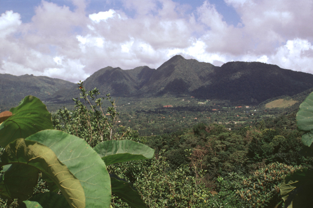 Three lava domes formed along the northern margin of the youngest of El Valle caldera, 80 km SW of Panama City. Cerro Pajita (left), Cerro Gaital (center), and Cerro Caracoral (right) rise above the caldera floor in this view from the SW caldera rim. The 6-km-wide El Valle de Antón caldera formed about 1 million years ago. Photo by Lee Siebert, 1998 (Smithsonian Institution).