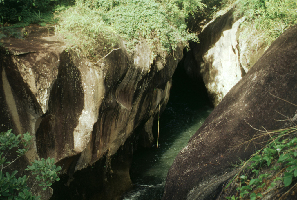 Deposits of the Liberia Tuff are exposed in gullies SW of Rincon de la Vieja. The ignimbrite was emplaced about 1.6 million years ago and covered an area of 3,500-4,000 km2. Eruption of the 25 km3 ignimbrite was associated with formation of the 15-km-wide Guachipelín caldera, inside which the modern Rincón de la Vieja massif was constructed. Photo by Lee Siebert, 1998 (Smithsonian Institution).