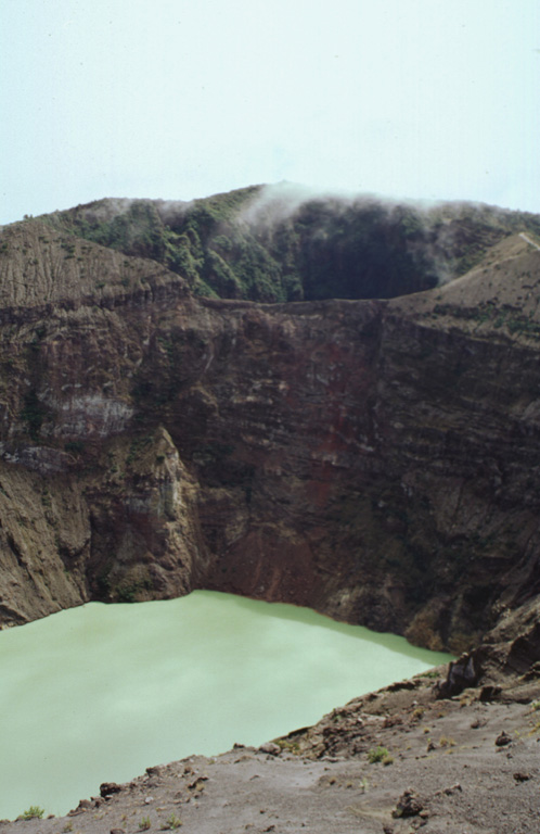 The two main summit craters of Irazú are seen here from the west in 1998. A lake fills the bottom of the main crater (Cráter Principal), with the older Diego de la Haya crater at the top of the photo.  Photo by Paul Kimberly, 1998 (Smithsonian Institution).