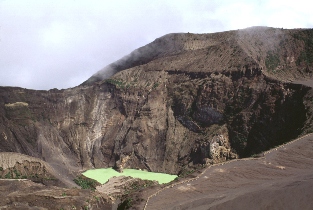 The Irazú main crater is about 700 m wide and 200 m deep. It is seen here in 1998 from the summit, with ash-covered Playa Hermosa (a largely buried older crater) to the lower right, and the edge of Diego de la Haya crater to the upper right.  Photo by Lee Siebert, 1998 (Smithsonian Institution).
