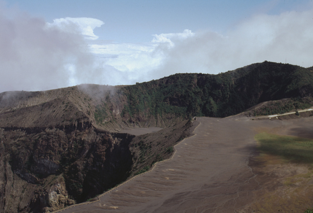 The infilled, 400 x 500 m wide Diego de la Haya crater in the background was the site of Irazú's first documented eruption in 1723. The eruption began on 16 February 1723, reached peak intensity in February and March, and continued sporadically until 11 December. Incandescent blocks and bombs were ejected, and ash fell on the cities of Cartago, San José, Barva, and Heredia. The active summit crater is to the lower left in this 1998 photo. Photo by Lee Siebert, 1998 (Smithsonian Institution).