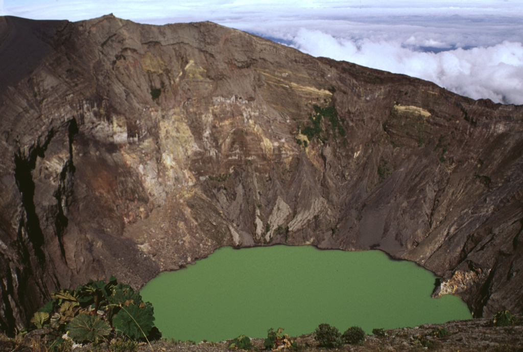 The Irazú summit crater is about 700 m wide and nearly 200 m deep and has been the source of most of Irazú's historical eruptions. Geothermal activity is frequently observed around of the lake, and the water color varies with changing atmospheric conditions. Photo by Lee Siebert, 1998 (Smithsonian Institution).