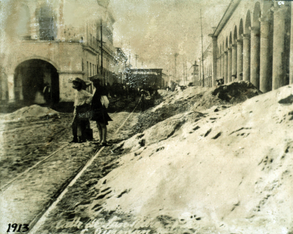 Ash deposits cleared from the streets of Ciudad Guzmán are piled up after the major explosive eruption of 20 January 1913. The eruption plume was calculated to have reached a height of 21 km, and the resulting ashfall caused significant disruption to the major city of Ciudad Guzmán, 25 km to the NE. Pyroclastic flows from this eruption reached as far as 17 km from the volcano. Anonymous, 1913.