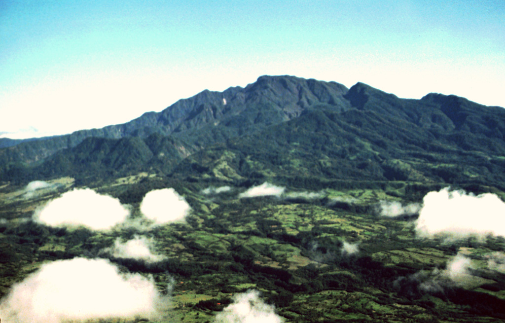 The SW flanks of Volcán Barú in the Talamanca Range of western Panama rise above agricultural lands at its base. A large 6-km-wide summit scarp opens towards the west (lower left) and is the result of a large flank collapse, which emplaced a massive debris avalanche deposit that underlies much of the farmlands in the foreground. Photo by Kathleen Johnson, 1995 (University of New Orleans).