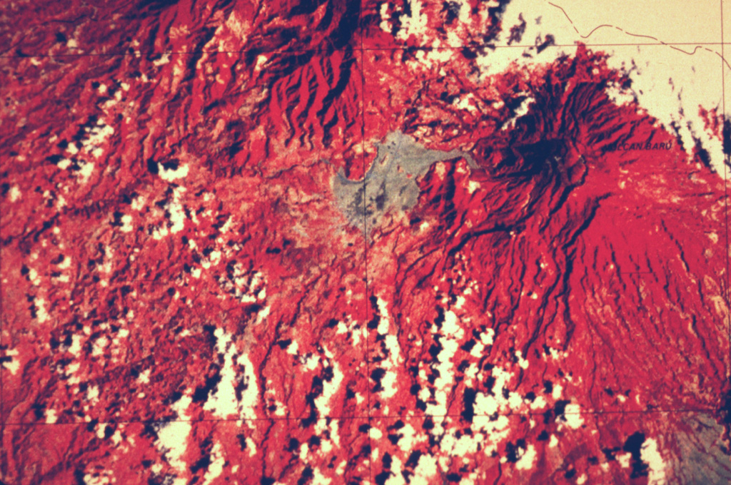 This false-color Landsat image shows two large Quaternary volcanoes in western Panamá. Barú volcano is at the upper right below the cloud cover, and Volcán Colorado lies at the top center. Virtually the entire lower left quadrant of the image is underlain by debris avalanche deposits produced by collapse of these two volcanoes, which left large scarps opening widely towards the W and SW. The light-colored area west of Barú consists of pyroclastic flow and lahar deposits related to lava dome growth. NASA Landsat satellite image (courtesy of Kathleen Johnson, University of New Orleans).
