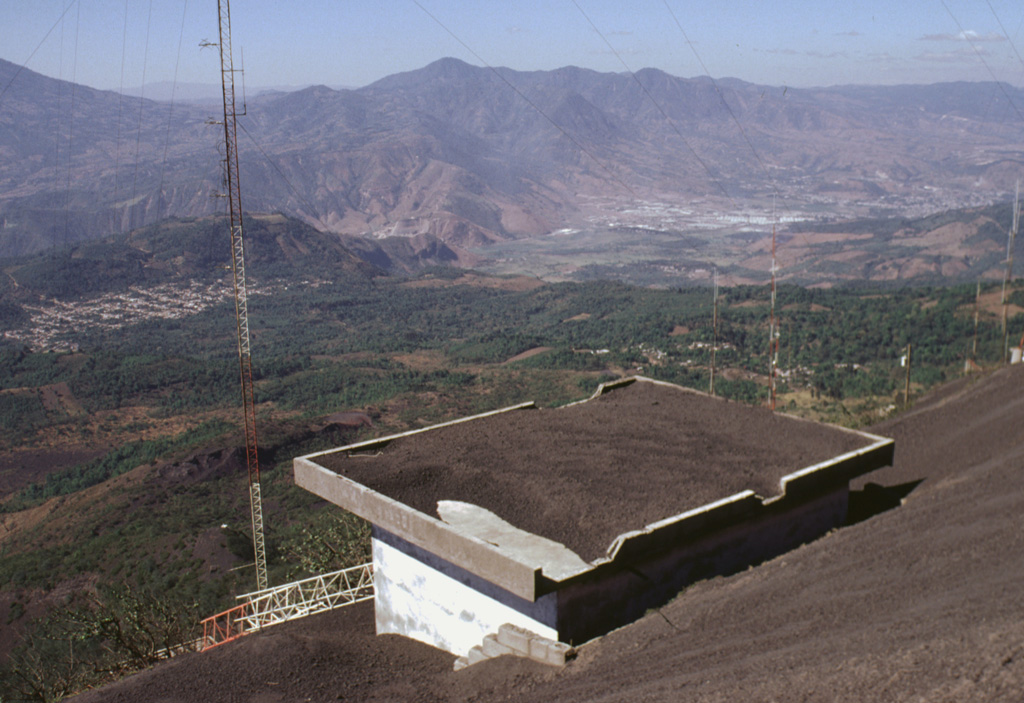 Tephra deposits from periodic larger eruptions of Pacaya coat a roof on Cerro Chino. A major eruption on 7 June 1995 caused the WNW side of Pacaya's crater to collapse, producing debris that slammed into the caldera wall at Cerro Chino, 1 km NW of the summit. A secondary hot cloud swept over Cerro Chino, destroyed a radio antenna, and affected houses within 2 km of the active vent. Photo by Lee Siebert, 1999 (Smithsonian Institution).