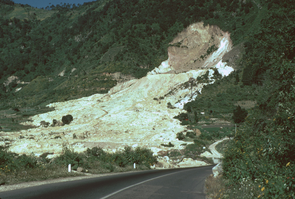 The 80-m-high headwall scarp of the 5 January 1991 landslide at the Almolonga volcano Zunil geothermal field exposes the regional Zunil fault zone. The avalanche deposit extends about 800 m from the source and damaged the highway between Quetzaltenango and the town of Retalhuleu on the Pacific coastal plain. The avalanche destroyed a church and more than a half-dozen houses, killing 23 people. The elevation difference from the head of the scarp to the distal end of the deposit was 250 m. Photo by Lee Siebert, 1993 (Smithsonian Institution).