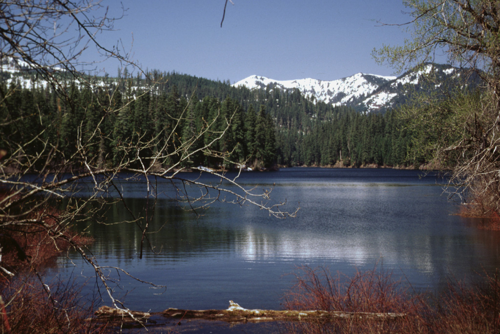 Fish Lake is an ephemeral lake on the western side of the Cascade Range crest that fills with water (seen here after spring snow-melt) but dries up during the summer. The lake formed when the Fish Lake lava flow from Nash Crater of the Sand Mountain volcanic field dammed local drainages. This flow and the Lava Lake flow from scoria cones at the northern half of the chain were both extruded about 3,850 radiocarbon years ago. Photo by Lee Siebert, 1999 (Smithsonian Institution).