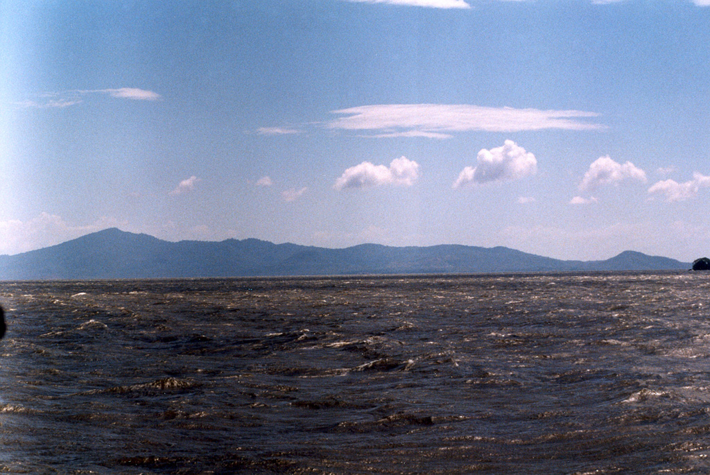 Zapatera Island is seen here from the north across Lake Nicaragua.  The 629-m-high summit of the island at the left marks the rim of a fault-bound caldera.  The post-caldera cone Cerro el Llano is a faintly visible conical peak whose summit lies just below the horizon near the center of the photo. Photo by Benjamin Van Wyk de Vries (Open University).