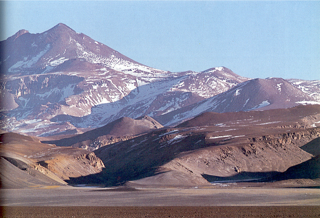 Volcán Copiapó in Atacama province is seen here from the north, with satellitic cones on its flanks.  The San Román eruptive center of probable Pleistocene age can be seen at the base of the volcano at the left-center.  Although the volcano was reported to have displayed solfataric activity, Holocene eruptive activity from Copiapó is uncertain. Photo by Oscar González-Ferrán (University of Chile).