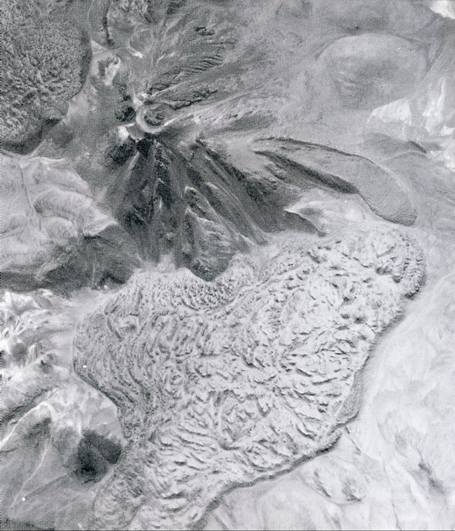 Two youthful large silicic lava flows flank the summit of Colachi volcano (upper left).  The larger flow (bottom) covers a 7 km2 area at the SE base of the volcano.  The smaller flow on the NW flank is visible at the upper left.  A smaller lava flow with pronounced lateral levees was erupted from a vent on the eastern flank. Photo by Insitituto Geográfico Militar, courtesy of Oscar González-Ferrán (University of Chile).