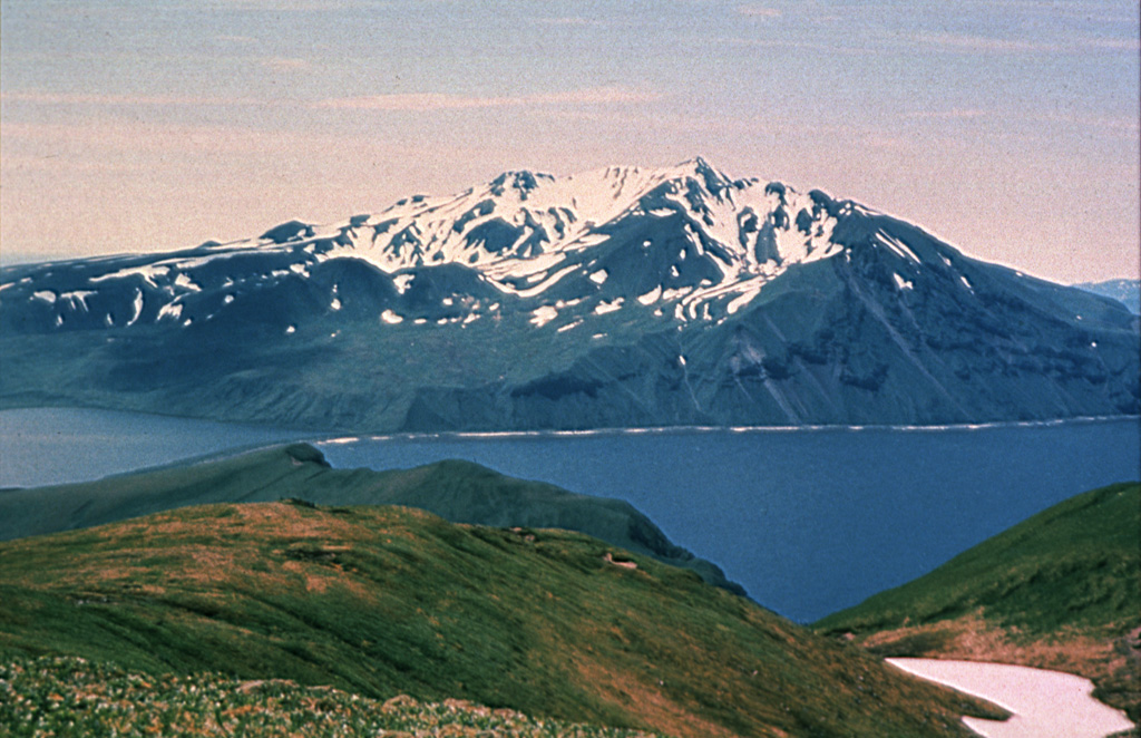 Mount Moffett has several flank lava domes and is seen here across Andrew Bay to the SW from Mount Adagdak. Andrew Bay volcano is the oldest of three volcanic centers on northern Adak Island. Mount Moffett rises above Adak (out of view to the left), the largest town of the Aleutians.  Photo courtesy of Alaska Volcano Observatory, U.S. Geological Survey.