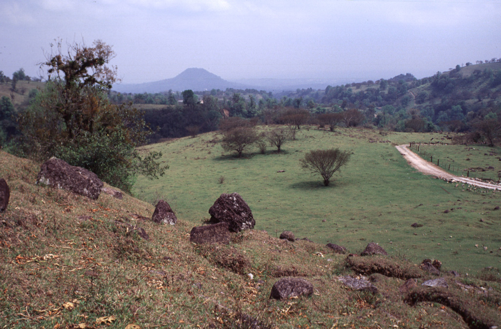 The slope in the foreground is the surface of the Xico debris avalanche deposit, which formed at the end of the Pleistocene during the youngest of several edifice collapse events at Cofre de Perote volcano. The highly mobile avalanche traveled into the Río Pescado drainage and covers an area of at least area ∼73 km2. Photo by Lee Siebert, 2000 (Smithsonian Institution).