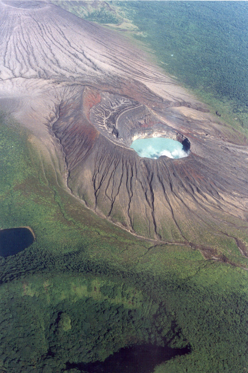 This photo from the E overlooks the Rincón de la Vieja summit cone complex  in the Rincón de la Vieja National Park. The turquoise-colored lake is within the Cráter Activo and the darker Laguna Fria is to the lower left. The arcuate, forested ridge to the lower left is the rim of Rincón de la Vieja cone itself. Erosional gullies have formed within tephra deposits across the Cráter Activo and the Von Seebach cone (upper left) flanks. Photo by Federico Chavarria Kopper, 1995 (courtesy of Eduardo Malavassi, OVSICORI-UNA).