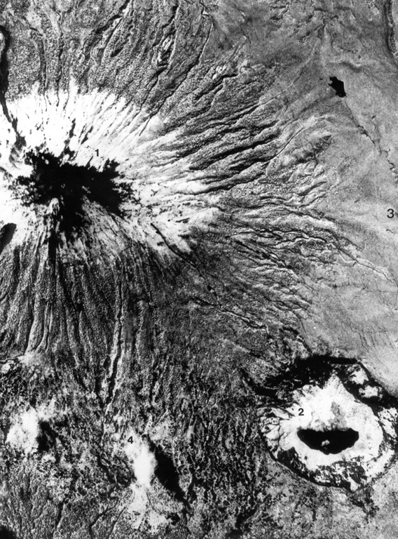 This aerial photo, with N to the upper left, shows Karisimbi (upper left) and the large 1.2-km-wide Muntango crater (lower right) located S of the summit; the 2-km-wide Branca caldera is located out of view to the right. The recent eruptions from Karisimbi produced a group of vents E of the caldera, which fed lava flows to the east, and the SW-flank lava vents. Aerial photograph courtesy of Henry Luc Hody (Belgian ambassador).