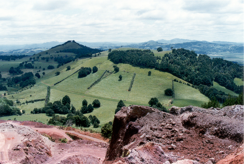 A group of scoria cones, one partially quarried in the foreground, lies at the NW side of the harbor city of Whangarei. The Whangarei volcanic field consists of Quaternary basaltic scoria cones and lava flows. The youngest basalts were initially mapped as Holocene, although the age of the field is not well known and could be late Pleistocene. Photo by Ichio Moriya (Kanazawa University).