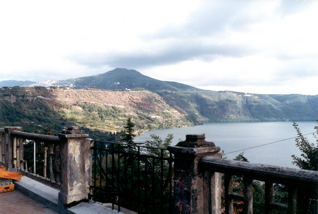 The lake-filled Albano maar is part of the Alban Hills (Monte Albano) complex immediately SE of Rome. The Cavo scoria cone rises beyond the far rim. The Monte Albano complex contains a large Pleistocene stratovolcano with a 10-km-wide caldera. Subsequent eruptions occurred from a 5-km-wide central cone as well as craters and cones within the caldera and on its outer flanks. The youngest known magmatic eruption occurred during the late-Pleistocene. Photo by Ichio Moriya (Kanazawa University).