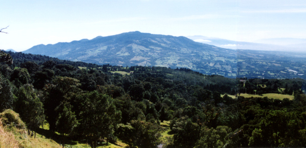 Barva volcano rises to the east above the southern flanks of neighboring Poás volcano.  The massive Barva volcano is dotted with numerous satellitic vents, some of which are visible along the irregular northern horizon (left).  Multiple lava flows descend the southern flank of Barva.  One of the more recent of these is the Los Angeles flow, which reaches nearly to the city of Heredia (out of view to the right).  Barva is the only one of four major stratovolcanoes near the capital city of San José that lacks confirmed historical eruptions.   Photo by Ichio Moriya (Kanazawa University).