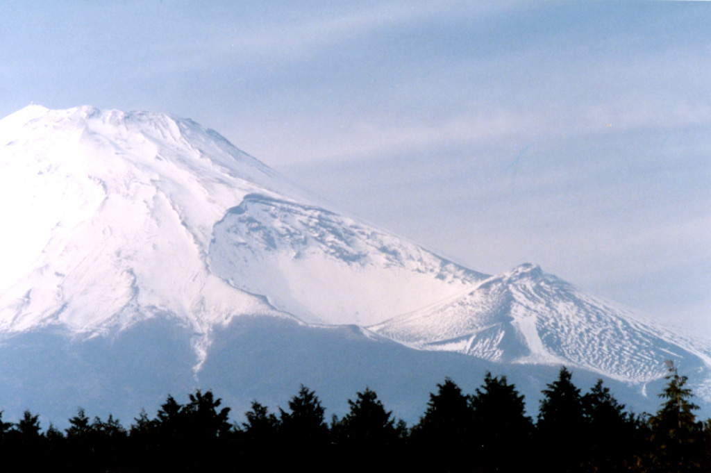 The large crater in the center of the photo was produced on the SE flank of Mount Fuji during the 1707-1708 eruption. This major explosive eruption ejected more than 1 km3 of tephra and resulted in ashfall in the capital city of Edo (Tokyo). Three craters were formed sequentially along a NW-SE-trend from the summit. The primary vent of the eruption was the upper crater (center), which is 750 x 1,500 m in size and 750 m deep from the highest point on the crater rim. Photo by Ichio Moriya (Kanazawa University).