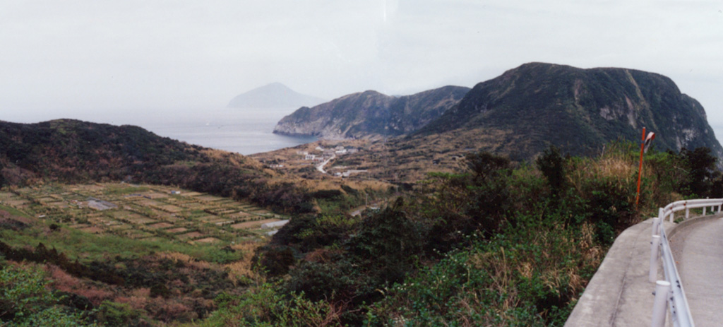 The agricultural area on floor of an explosion crater (left) and a flat-topped lava dome (right) are part of Kozushima volcano in the northern Izu Islands. The small 4 x 6 km island formed by a cluster of rhyolitic lava domes and associated pyroclastic deposits. The youngest and largest dome, Tenjoyama, occupies the central portion of the island. Most of the older domes are to the north. Two historical eruptions occurred during the 9th century. Photo by Ichio Moriya (Kanazawa University).
