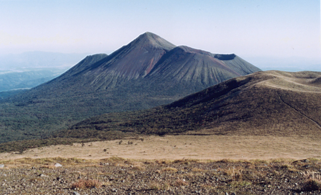 Takachihomine peak (center) in the Kirishima volcanic complex is flanked on the E (right) by Ohachi, with its broad summit crater. Madudake cone is to the far right. Kirishima is a large group of more than 20 Quaternary cones within Kirishima National Park, located N of Kagoshima Bay. The late-Pleistocene to Holocene group of cones, maars, and underlying shield volcanoes occupies an area of 20 x 30 km. Photo by Ichio Moriya (Kanazawa University).