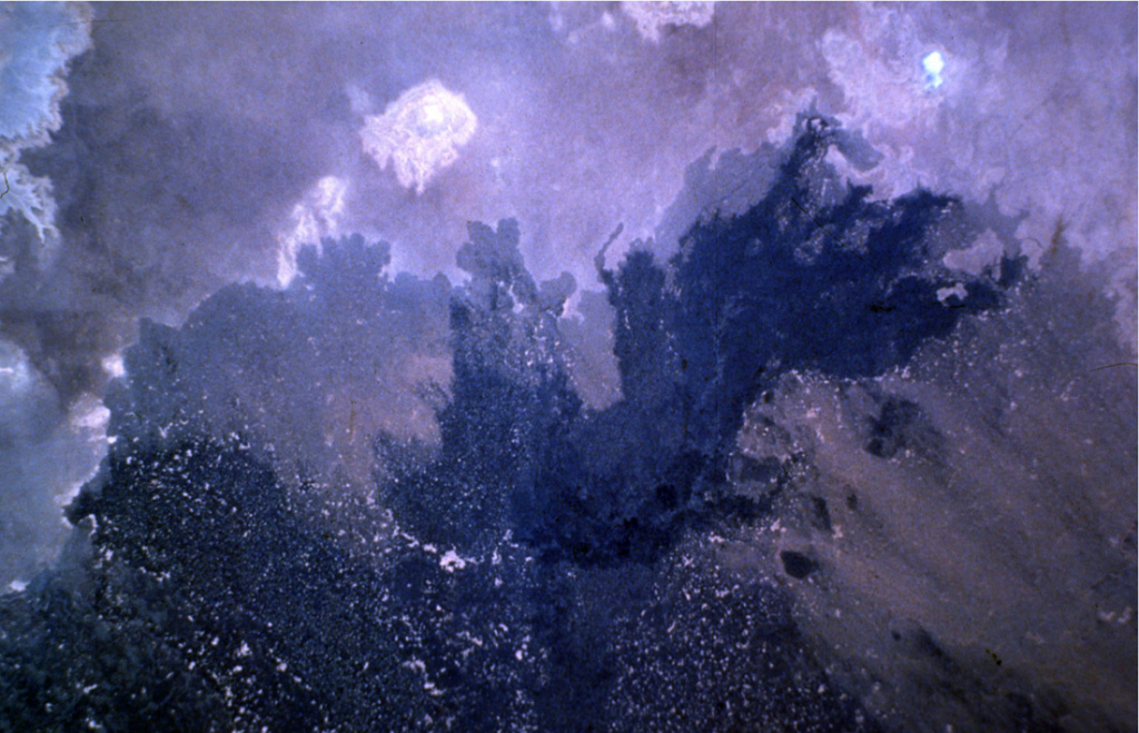 Dark-colored lava flows of the Haruj volcanic field are prominent in this Space Shuttle photo of the arid desert of central Libya.  The extensive Pliocene-to-Holocene Haruj volcanic field covers a broad 45,000 km2 area and contains very well-preserved scoria cones, lava flows, and explosion craters.  The youngest lava flows were considered to be Holocene in age. NASA Space Shuttle image STS41C-32-1146, 1984 (http://eol.jsc.nasa.gov/).