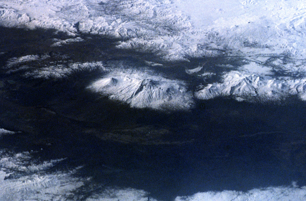 The snow-covered Mount Ararat massif is seen in the center of this 1992 Space Shuttle photo from the NE. The double-peaked stratovolcano is Turkey's highest, largest volume, and eastern-most volcano, near the borders with Armenia and Iran. Postglacial lava flows were erupted from flank fissures, and well-preserved craters are located on the flanks. NASA Space Shuttle image, 1992 (http://eol.jsc.nasa.gov/).