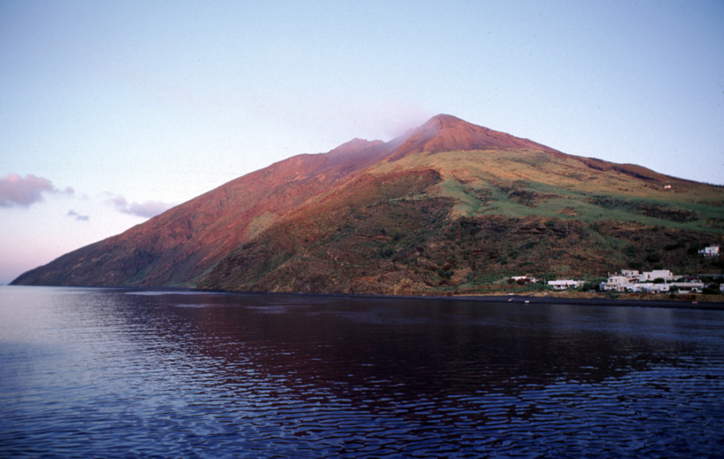 This view of Stromboli shows the NE tip of the island with the Rina Grande valley at the left. The principal historically active vent of Stromboli lies at the head of the Sciarra del Fuoco, a prominent scarp on the opposite side of the island. Stromboli, the NE-most of the Aeolian Islands, has produced frequent mild explosions throughout much of historical time. Photo by Guiseppina Kysar, 1999 (Smithsonian Institution).