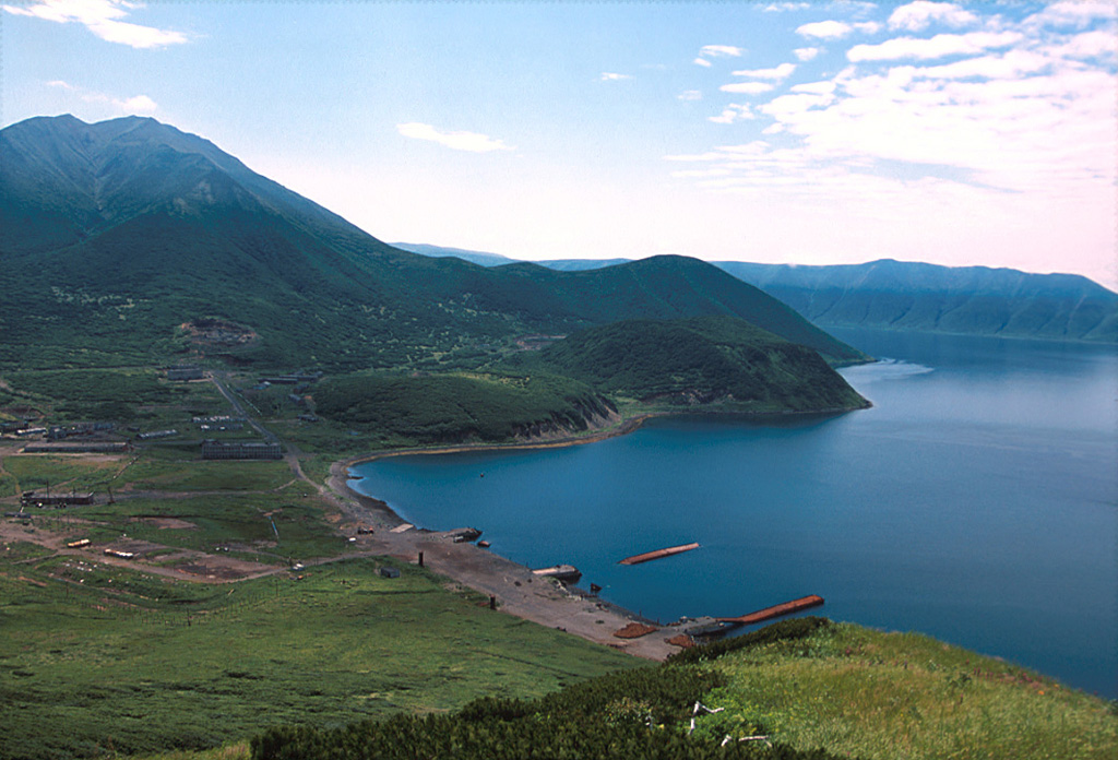 A large post-caldera cone (upper left) was constructed in the SE part of the Uratman caldera, the northernmost volcano on Simushir Island. The caldera is partially filled by Brouton Bay, shown here. Two cones and a lava dome are on the northern flank of the larger cone in this view from the NE caldera rim. Photo by Yoshihiro Ishizuka, 2000 (Hokkaido University).