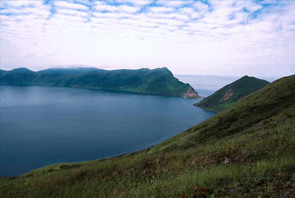 A narrow gap in the NNE rim of the Pleistocene Brouton caldera resulted in the formation of Brouton Bay. The caldera floor lies 250 m beneath the ocean surface and the rim rises 450 m above it.  Photo by Yoshihiro Ishizuka, 2000 (Hokkaido University).