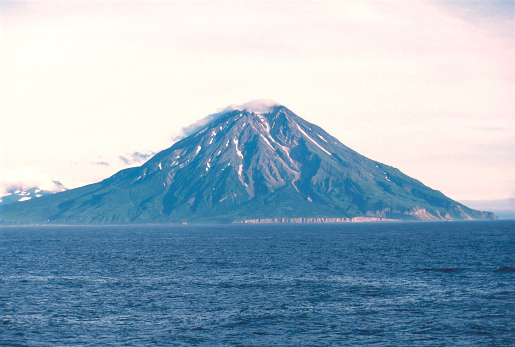Fuss Peak forms a peninsula on the SW coast of Paramushir Island, the largest of the Kuril Islands. The cone has a 700-m-wide, 300-m-deep crater. A valley extends from a low point in the crater rim down to the coast on the NW flank. Photo by Yoshihiro Ishizuka, 2000 (Hokkaido University).