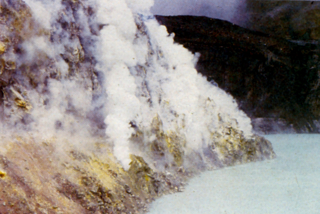 Gases emanate from fumaroles within the sulfur-lined wall of a lava dome at the bottom of the Poás active crater. The turquoise-colored crater lake is among the most acidic natural waters on Earth. The hot lake has been the source of frequent phreatic eruptions that produce plumes of steam, ash, and mud.  Photo by Guillermo Alvarado (Instituto Costarricense de Electricidad).