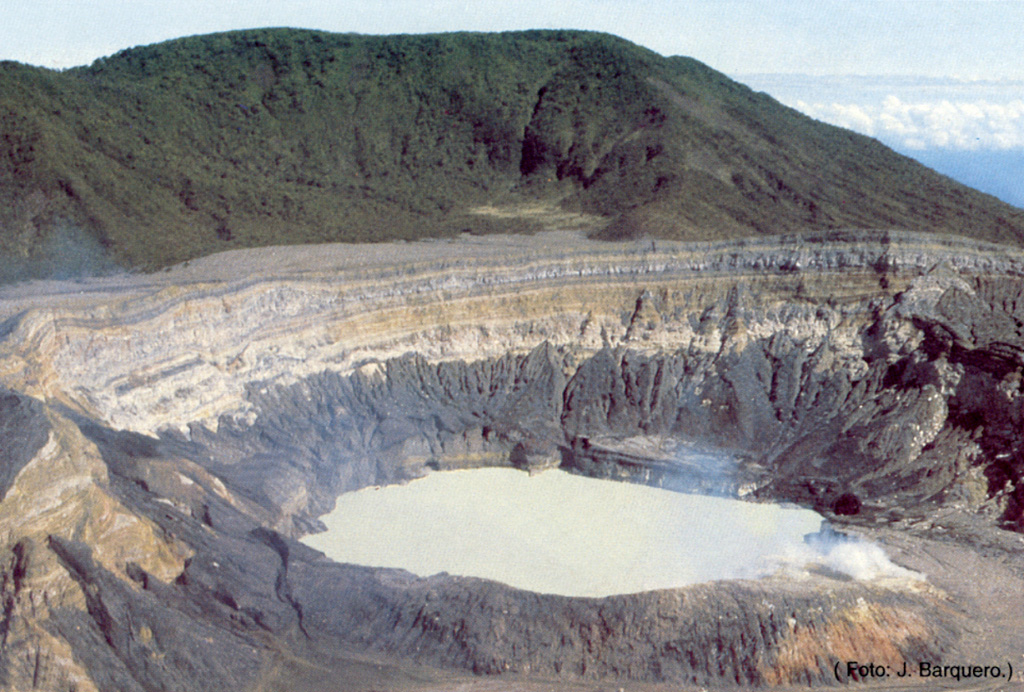 The acidic crater lake at the summit of Poás is seen here from the overlook on the southern crater rim. The von Frantzius cone in the background formed along the northern rim of the innermost of two large nested calderas at the summit. The crater lake has been the source of frequent phreatic eruptions. Photo by Jorge Barquero, 1985 (Universidad Nacional Costa Rica).