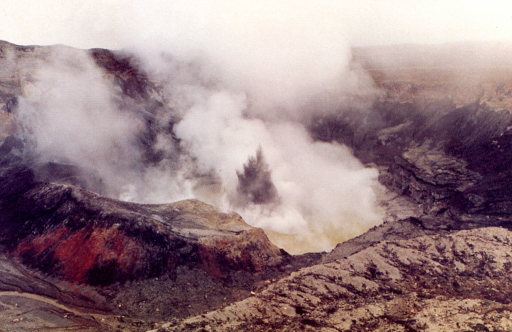 Ash and mud from a small phreatic explosion rise above the degassing Poás crater lake on 28 August 1988. Phreatic explosions had been occurring since June of the previous year and lasted for a few more months beyond August 1988. Activity was nearly continuous during the second half of August and the first week of September, with plumes containing mud rising 5-10 m. During the rest of the month plumes rose as much as 25 m. Small explosions continued, and by April 1989 the crater lake disappeared.  Photo by E. Valverde, 1988 (published in Barquero, 1998)