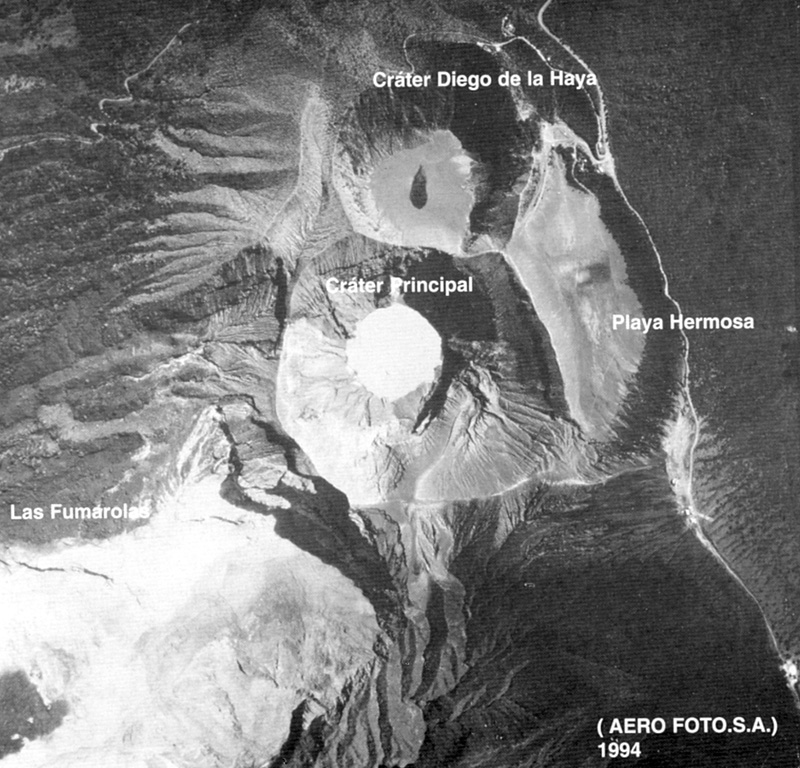 The Irazú summit crater complex is seen in this aerial view with north to the left. The Diego de la Haya crater is at the top and then to the main crater (Cráter Principal) contains a small lake. Playa Hermosa is a largely buried older crater. The road at the right leads to communication towers at the summit (lower right). Aerofoto S. A., 1994 (published in Barquero, 1998).