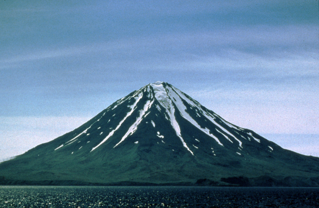 Carlisle rises above the Carlisle Pass strait across from Mount Cleveland. Several poorly documented eruptions have been recorded since the 18th century. Carlisle is one of group of volcanoes in the "Islands of Four Mountains" area of the central Aleutians. Photo by Michelle Harbin, 1994 (courtesy of U.S. Geological Survey, Alaska Volcano Observatory).